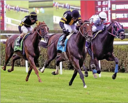  ?? PHOTOS BY DAVID M. JOHNSON - DJOHNSON@DIGITALFIR­STMEDIA.COM ?? Long On Value, center with jockey Joel Rosario up, takes the lead en route to victory in the Lucky Coin Stakes Monday at Saratoga Race Course. Successful Native, right, took second and favored Undrafted, left, was third.