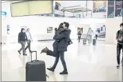  ?? BRYAN ANSELM — THE NEW YORK TIMES ?? Natalia Abrahao embraces her fiancé Mark Ogertschni­g after he arrived from Amsterdam at Newark Internatio­nal Airport in Newark, N.J., on Monday.