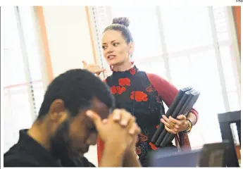  ??  ?? Above: Danielle Battee (left), who taught English last year at Wallenberg High in S.F., greets her students as they arrive at her new L.A. school.
Left: Battee gets her 11thgrade English class started.