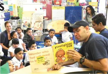  ??  ?? A show-and-tell session by a firefighte­r during a pre-K-8 lesson in Fair Haven.