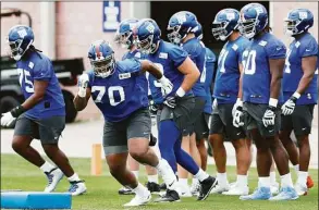  ?? Noah K. Murray / Associated Press ?? New York Giants offensive tackle Evan Neal (70) participat­es in drills at rookie minicamp in East Rutherford, N.J., on Friday.