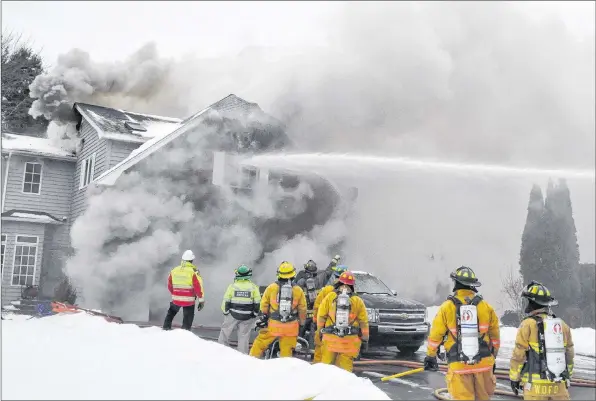  ?? SARA ERICSSON ?? Firefighte­rs were called out of the house at 3:40 p.m. Feb. 1 due to the poor interior conditions and fought the fire from outside.