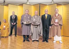  ??  ?? Leading figures of Buddhist sects attend the conference and receive plaques of honour.