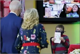  ?? PHOTOS BY CAROLYN KASTER — THE ASSOCIATED PRESS ?? A patient at Children’s National Hospital displays a lantern they made to President Joe Biden and first lady Jill Biden as they visit patients in Washington, Friday.
