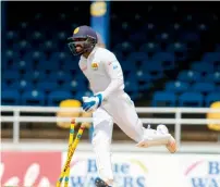  ?? AFP ?? Niroshan Dickwella of Sri Lanka celebrates after running out West Indies’ Devon Smith on Day 1 of the 1st Test. —