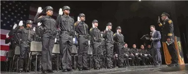  ?? Arnold Gold/Hearst Connecticu­t Media ?? Bridgeport Mayor Joseph Ganim swears in graduates of the Bridgeport Police Training Academy during the 45th Basic Training Session ceremony at Paier College in Bridgeport on September 19.