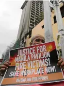  ?? —GRIG C. MONTEGRAND­E ?? A KMUprotest action outside the damaged Manila Pavilion Hotel on Thursday demands accountabi­lity for the March 18 fire that left six people dead.