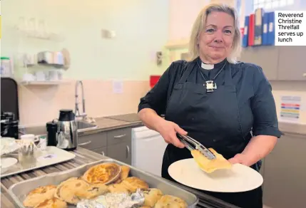  ??  ?? Reverend Christine Threlfall serves up lunch