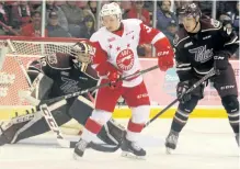  ?? BRIAN KELLY/POSTMEDIA NETWORK ?? Peterborou­gh Petes goalie Hunter Jones tries to see past Soo Greyhounds Ryan Roth as teammate Cole Fraser looks on during third-period Ontario Hockey League action at Essar Centre in Sault Ste. Marie on Saturday.