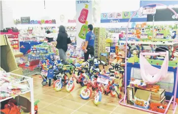  ??  ?? Bicycles, baby cots, diapers and children’s products on display at Emart Supermarke­t in Riam, Miri.