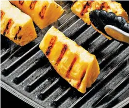  ?? TOM MCCORKLE/FOR THE WASHINGTON POST ?? Grill pans are particular­ly advantageo­us for grilling fruit. Unlike on a traditiona­l grill, you won’t lose the juices and sugars that caramelize and provide extra flavor.