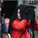  ?? Photos by Michelle Cooper Galvin ?? Hiding from the cameras, Marcus O’Rourke (left) and Brian O’Sullivan, pictured in 2016 leaving a Special Sitting of the District Court in Killarney.