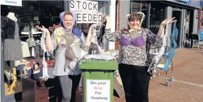  ??  ?? ●● Headway manager Sue Watkins (right) and assistant manager Helen Share with some of the donations