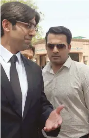  ?? — AFP ?? Suspended Pakistani cricketer Sharjeel Khan (right) walks with his lawyer after appearing before a tribunal in Lahore on Friday.