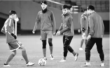  ??  ?? North Korea’s An Byong Jun (third left) and Lee Yong Jick (second left) attend a training session for East Asian Football Championsh­ip at Ajinomoto Stadium in Tokyo, Japan. — Reuters photo