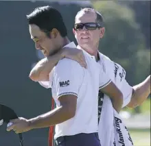  ?? Steve Helber/Associated Press ?? Kevin Na, left, hugs his caddie after winning at The Greenbrier Sunday in White Sulphur Springs, W.Va.