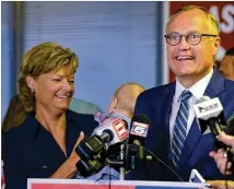  ?? JENNA EASON / JENNA.EASON@COXINC.COM ?? Lt. Gov. Casey Cagle, with his wife, Nita, speaks to local media outlets and supporters Monday at DeKalb-Peachtree Airport before a statewide fly-around. Cagle says he’ll win if all of his voters in May cast ballots for him today.