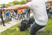  ?? Casey Toth / Durham (N.C.) Herald-Sun ?? A man kicks a statue of a Confederat­e soldier after it was pulled down Monday in Durham, N.C.