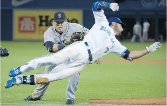  ?? NATHAN DENETTE / THE CANADIAN PRESS ?? Blue Jays’ Kevin Pillar makes a diving attempt to reach first base but was tagged out by Seattle first baseman Justin Ruggiano in the ninth inning on Friday night in Toronto.