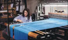  ?? TIZIANA FABI / AGENCE FRANCE-PRESSE ?? A woman works in the L’Antico Setificio Fiorentino silk factory in Florence, Italy.