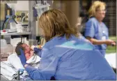  ?? TY WRIGHT / THE NEW YORK TIMES ?? A nurse feeds a newborn going through opioid withdrawal at Baptist Health in Richmond, Kentucky, last March.