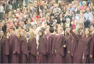  ?? BRIAN MCINNIS/THE GUARDIAN ?? Graduates of Colonel Gray Senior High School walk into the UPEI gym past proud parents with cameras blazing during the school's 2015 graduation exercises on June 23.