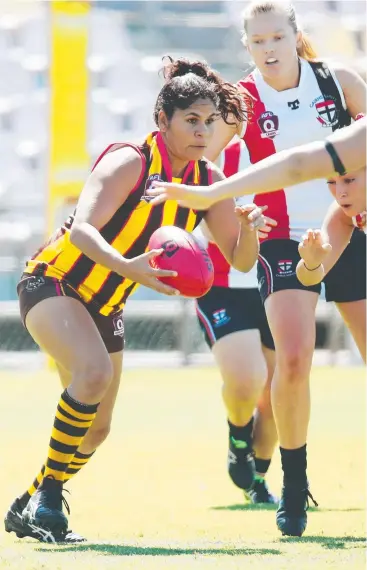  ?? Picture: BRENDAN RADKE ?? TIGHT TUSSLE: Manunda Hawks’ Asta Naden clears the ball away from her team's goals in the match against Cairns Saints at Cazalys Stadium.