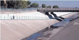  ?? ROBERTO E. ROSALES/JOURNAL ?? A bicyclist heads south past Osuna on the underpass running along the North diversion channel.