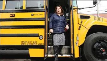  ?? NANCY LANE — BOSTON HERALD ?? School Superinten­dent Mary Skipper steps off a new electric bus on Feb. 6 after a transporta­tion announceme­nt.
