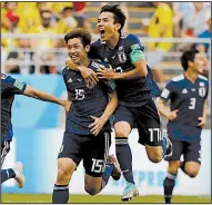  ?? AP/EUGENE HOSHIKO ?? Japan’s Yuya Osako (15) celebrates with teammate Makoto Hasebe after scoring the go-ahead goal in Tuesday’s World Cup victory over Columbia at Saransk, Russia.