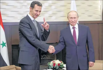  ?? AP PHOTO ?? Russian President Vladimir Putin , shakes hands with Syrian President Bashar Assad during a meeting Monday in the Black Sea resort of Sochi, Russia.