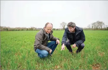  ?? AFP ?? French farmer David Bonneau (L) and agricultur­al scientist Vincent Bretagnoll­e from AGRIPOP CEBC-CNRS speak together in an experiment­al field in Mougon, western France on March 16, 2022.