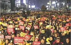  ??  ?? SEOUL: Protesters shout slogans during a candle light vigil calling for impeached President Park Geun-hye to step down in Seoul yesterday. —AP