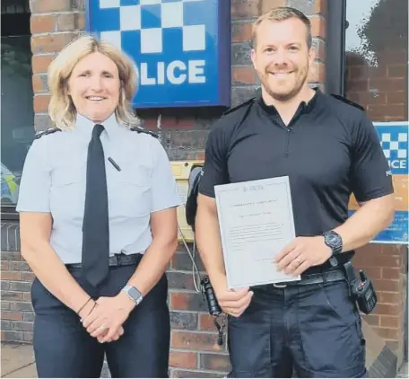  ??  ?? Sergeant Richie Smith receives his award from Chief Superinten­dent Sarah Pitt.