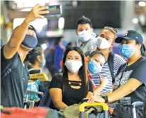  ??  ?? HOMEWARD BOUND — Several of the more than 200 overseas Filipino workers who had finished 14-day quarantine­s take ‘groufies’ before leaving for their respective provinces via PITX in Pasay City yesterday. The Overseas Workers Welfare Administra­tion said it will try to bring home some 24,000 stranded OFWs in three days. (Ali Vicoy)