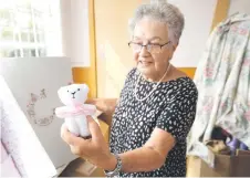  ?? ?? A member of the coffin club showing a small bear that goes into a coffin for a baby during a work day.