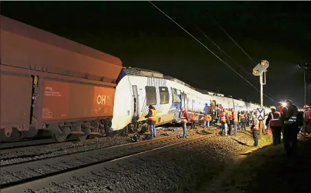  ?? — Reuters ?? No fatalities: Rescuers standing next to damaged carriages at the site of the train crash in Meerbusch, Germany.