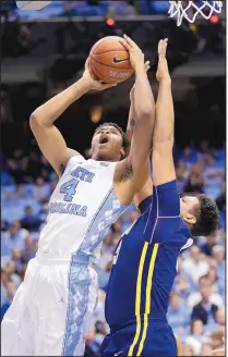  ?? GERRY BROOME/THE ASSOCIATED PRESS ?? Isaiah Hicks (4) of seventh-ranked North Carolinas shoots against UNC Greensboro during the first half Monday in Chapel Hill, N.C. Hicks had 13 points.