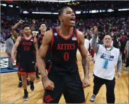  ?? ROB CARR – GETTY IMAGES ?? Keshad Johnson and his San Diego State teammates are elated following Friday's 71-64win over No. 1overall seed Alabama in a West Region semifinal in Louisville, Ky.