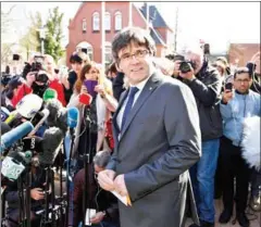  ?? PATRIK STOLLARZ/AFP ?? Catalonia’s ousted leader Carles Puigdemont arrives to speak to the press as he leaves the detention centre of Neumuenste­r, northern Germany, on Friday.