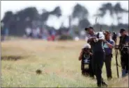  ?? ALASTAIR GRANT — THE ASSOCIATED PRESS ?? Tiger Woods of the US plays out of the rough on the 18th hole during the third round of the British Open Golf Championsh­ip in Carnoustie, Scotland, Saturday.