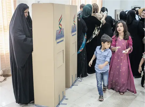  ?? CHRIS MCGRATH / GETTY IMAGES ?? People cast their referendum votes Monday at a voting station in Irbil despite strong objection from neighbouri­ng countries and the Iraqi government. Some five million Kurds took to the polls in the referendum.