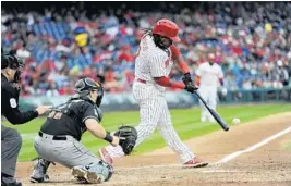  ?? MICHAEL PEREZ/AP ?? Maikel Franco hits a grand slam in the first inning off Marlins starting pitcher Dillon Peters, who gave up nine runs and nine hits.