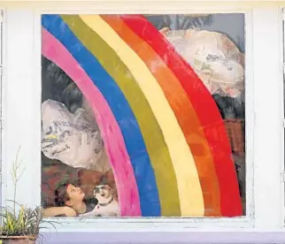  ??  ?? Goldie Alfonso, 10, along with her dog, Maggie, admire the rainbow and clouds she created with her mother, Alissa, for their home’s window. “My daughter and I wanted to spread hope and positivity,” Alfonso said.