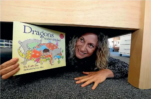  ?? MARTIN DE RUYTER/ STUFF ?? ‘‘I tried to get them published years and years ago but didn't have any luck.’’
Kath Bee Kath Bee with her book Dragons Under My Bed.