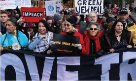  ??  ?? Jane Fonda (center, in red) leads hundreds of people in a march from the US Capitol to the White House. Photograph: Chip Somodevill­a/Getty Images