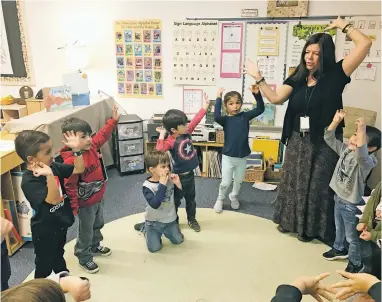  ?? ROBERT NOTT/THE NEW MEXICAN ?? Pre-K teacher Rebecca Scott Gonzales leads her class of 4-year-olds in a song and dance about trees, branches, soil, roots and the environmen­t. ‘I tell all families that this program doesn’t prepare kids for kindergart­en,’ Gonzales says. ‘It prepares them for life.’