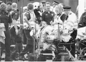  ?? CARL COURT/GETTY IMAGES ?? A member of the public is treated near Westminste­r Bridge and the Houses of Parliament in London on Wednesday.