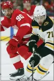  ?? DUANE BURLESON — THE ASSOCIATED PRESS ?? Detroit Red Wings’ Joe Veleno, left, pursues Boston Bruins’ Taylor Hall during Sunday’s home loss.