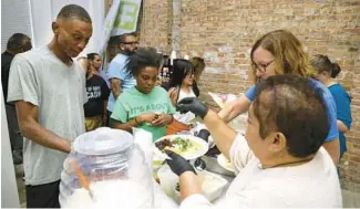  ?? ?? Steven Hill, left, and Alexandra Singleton, center, arrive at Hope Church’s weekly food service.